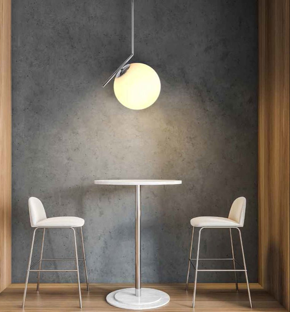 Chrome metal opal white glass globe pendant light m with e27 fitting in indoor setting cafe table top