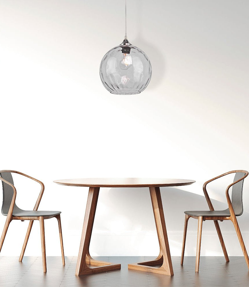 Clear glass globe pendant light with e27 fitting in indoor setting cafe table top