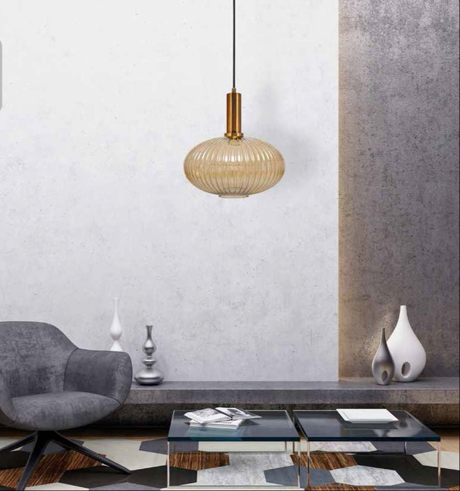 Golden bronze metal amber glass globe pendant light l with e27 fitting in indoor setting