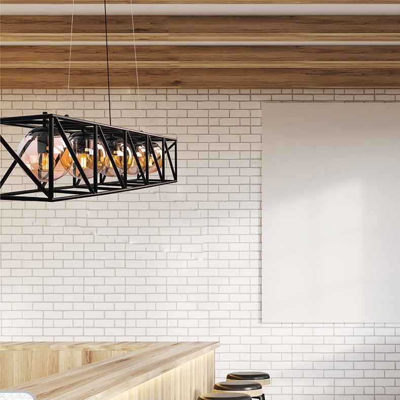 Black cuboid metal cylinder amber glass island chandelier with 5xe27 fitting in indoor setting cafe bar top